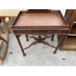 A REPRODUCTION CHIPPENDALE OCCASIONAL TABLE WITH A PIERCED GALLERY TOP AND PIERCED FRETWORK CROSS