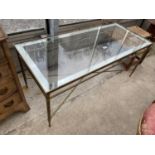 A COFFEE TABLE WITH GLASS TOP ON BRASS ROPE-TWIST STRETCHERS WITH FLUTED LEGS 44"X19"