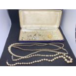 A BLUE VELVET PRESENTATION BOX WITH THREE PEARL NECKLACES, EARRINGS AND SPARES