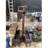 TWO WOODEN PLANTER TROUGHS AND A WOODEN BIRD TABLE