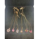 SIX SILVER NECKLACES WITH ROSE GILT AND COLOURED STONE PENDANTS