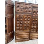 A SPANISH WALNUT HEAVILY PANELED WALL UNIT WITH TWO CUPBOARDS AND THREE DRAWERS TO THE BASE (W: 35.5