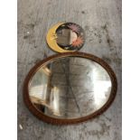 AN ORNATE GILT OVAL FRAMED MIRROR AND ANOTHER WITH MOON FACES