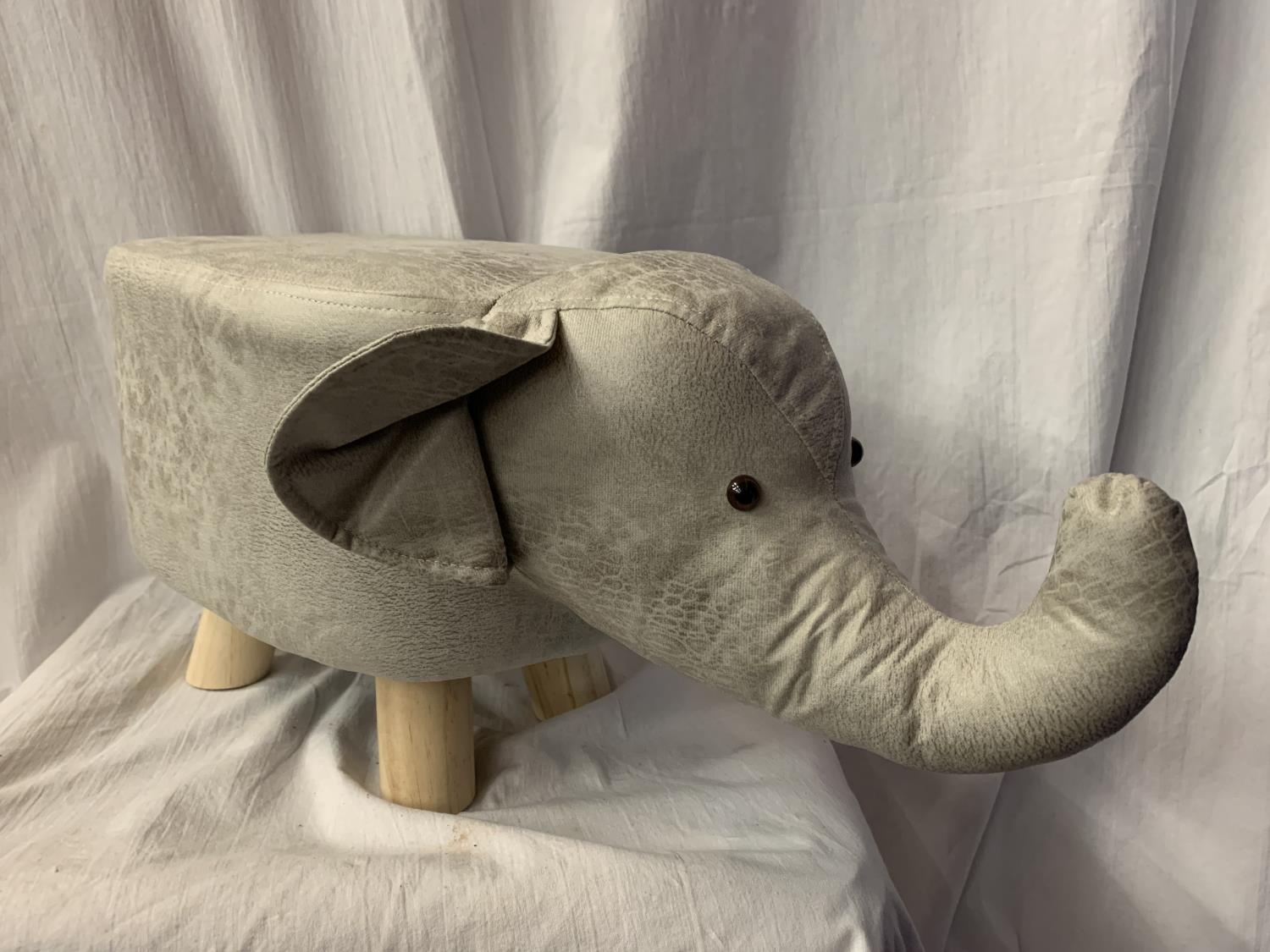 A FAUX LEATHER CHILD'S FOOT STOOL IN THE FORM OF AN ELEPHANT