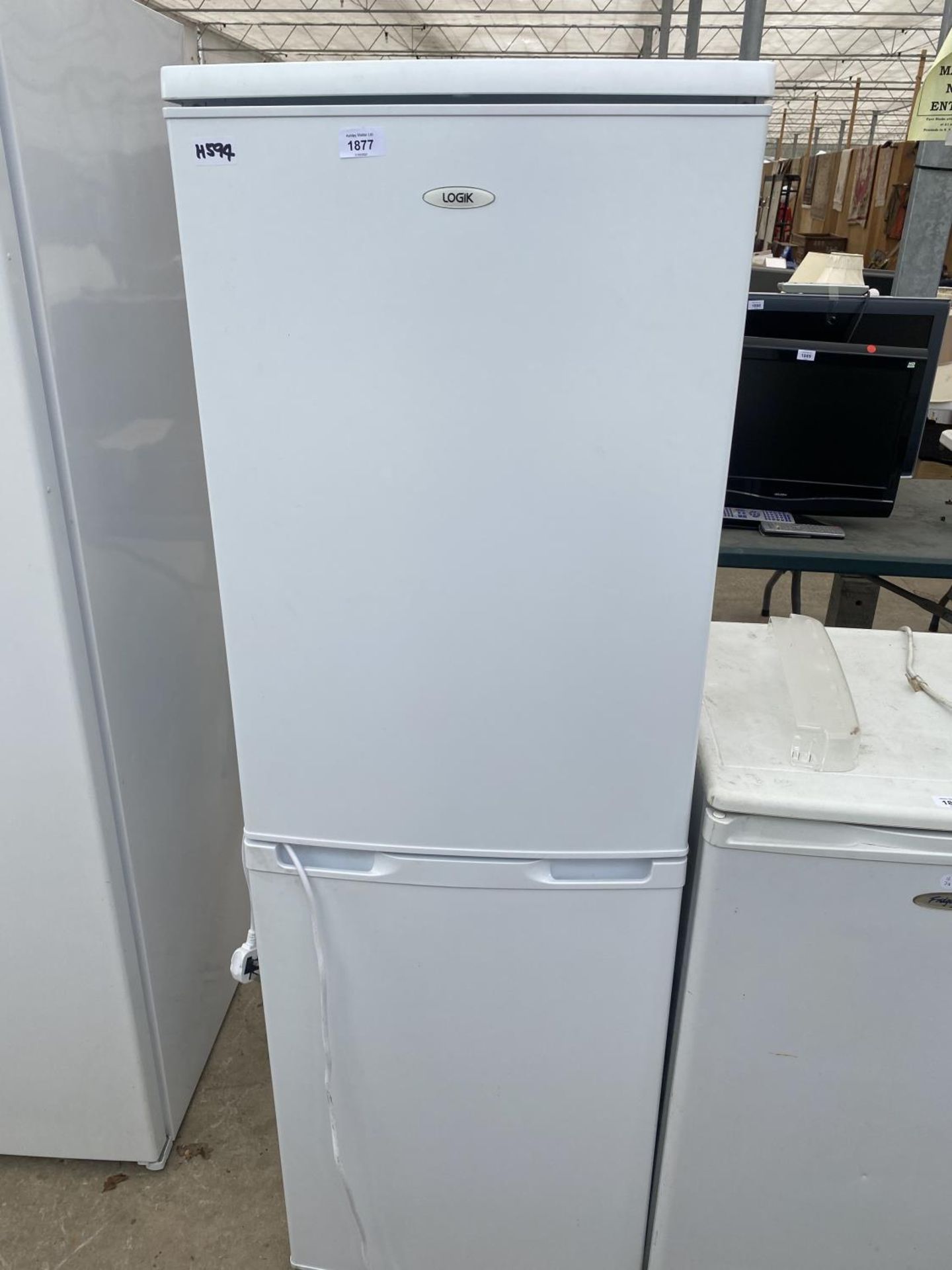 A WHITE LOGIK UPRIGHT FRIDGE FREEZER BELIEVED IN WORKING ORDER BUT NO WARRANTY