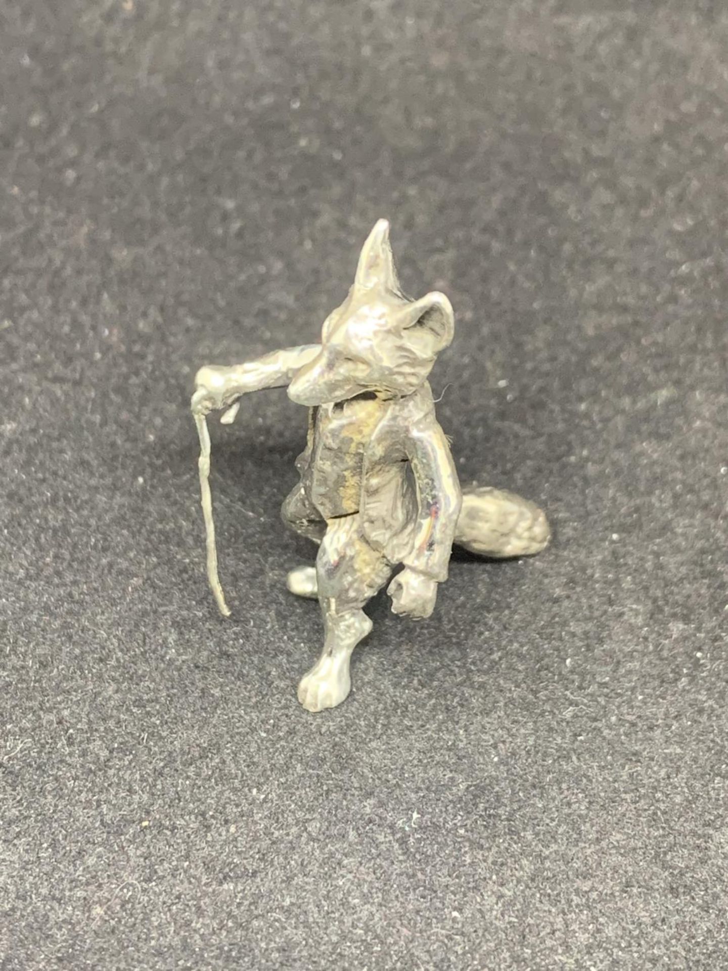 A MINIATURE SILVER STANDING FOX WITH CANE