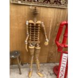 A LIFE SIZE MANNEQUIN FIGURE CONSISTING OF CUT AND SHAPED PLYWOOD AND FABRICATED PLASTIC JOINTS (H: