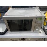 A SILVER SANYO MICROWAVE OVEN BELIEVED IN WORKING ORDER BUT NO WARRANTY