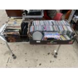 A LARGE ASSORTMENT OF CDS, RECORDS AND DVDS