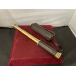 A LEATHER CASED BRASS TELESCOPE EXTENDS TO 34CM