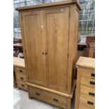 A LIGHT OAK TWO DOOR WARDROBE WITH SINGLE DRAWER TO THE BASE, 42" WIDE