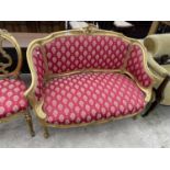 A 19TH CENTURY STYLE GILT TWO SEATER PARLOUR SETTEE WITH FOLIAGE DECORATION