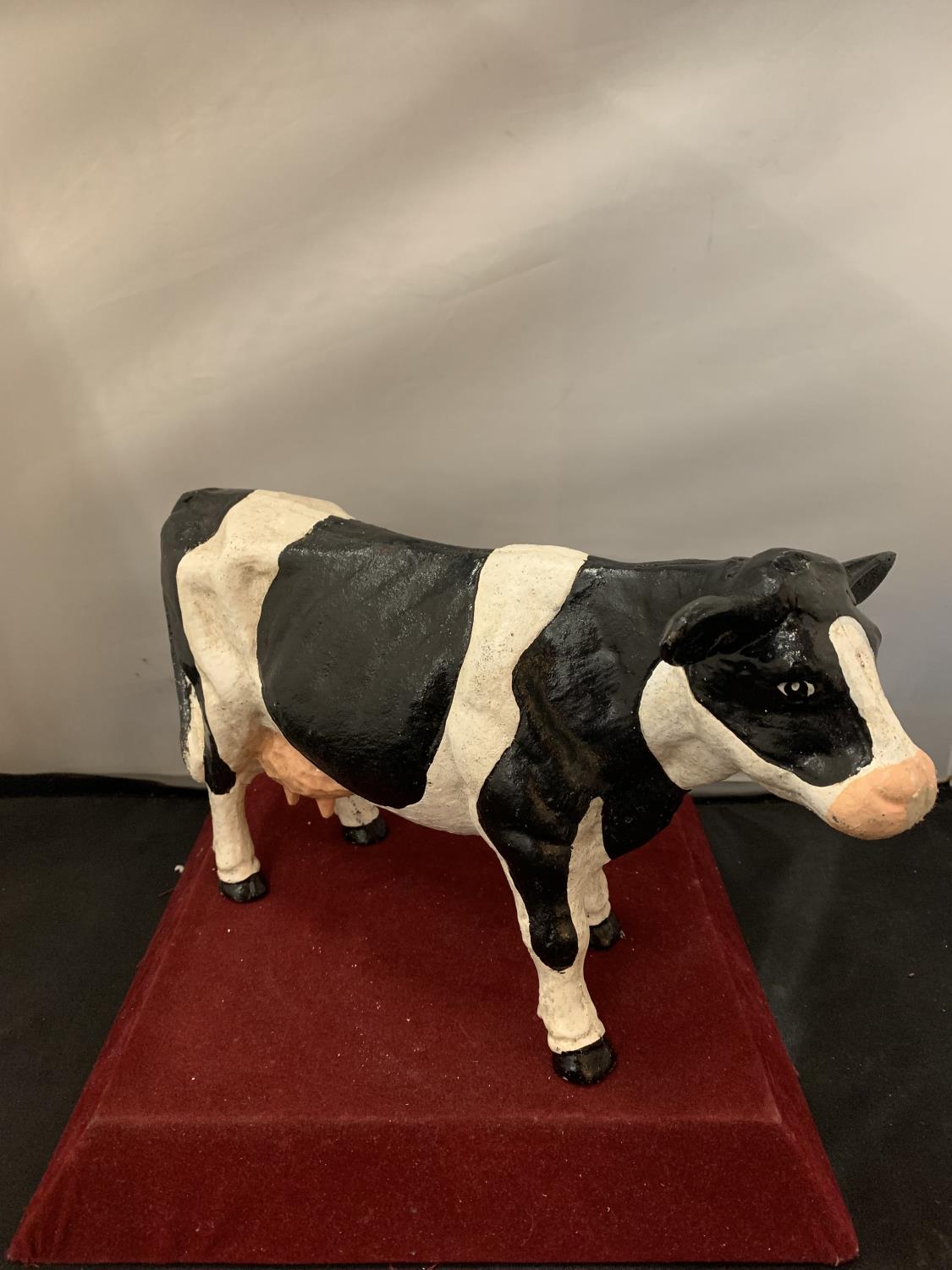 A HEAVY CAST HAND PAINTED BLACK AND WHITE COW DOORSTOP WEIGHING APPROXIMATELY 5 KG H: 20CM