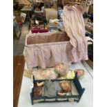 A LARGE VINTAGE COT, THREE VINTAGE DOLLS AND A WOODEN BED