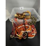 A PLASTIC CONTAINER OF COSTUME JEWELLERY TO INCLUDE MAINLY NECKLACES