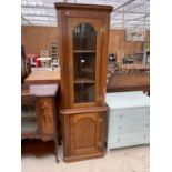 A REPRODUCTION OAK CORNER CUPBOARD WITH GLAZED UPPER PORTION AND H-BRASS HINGES