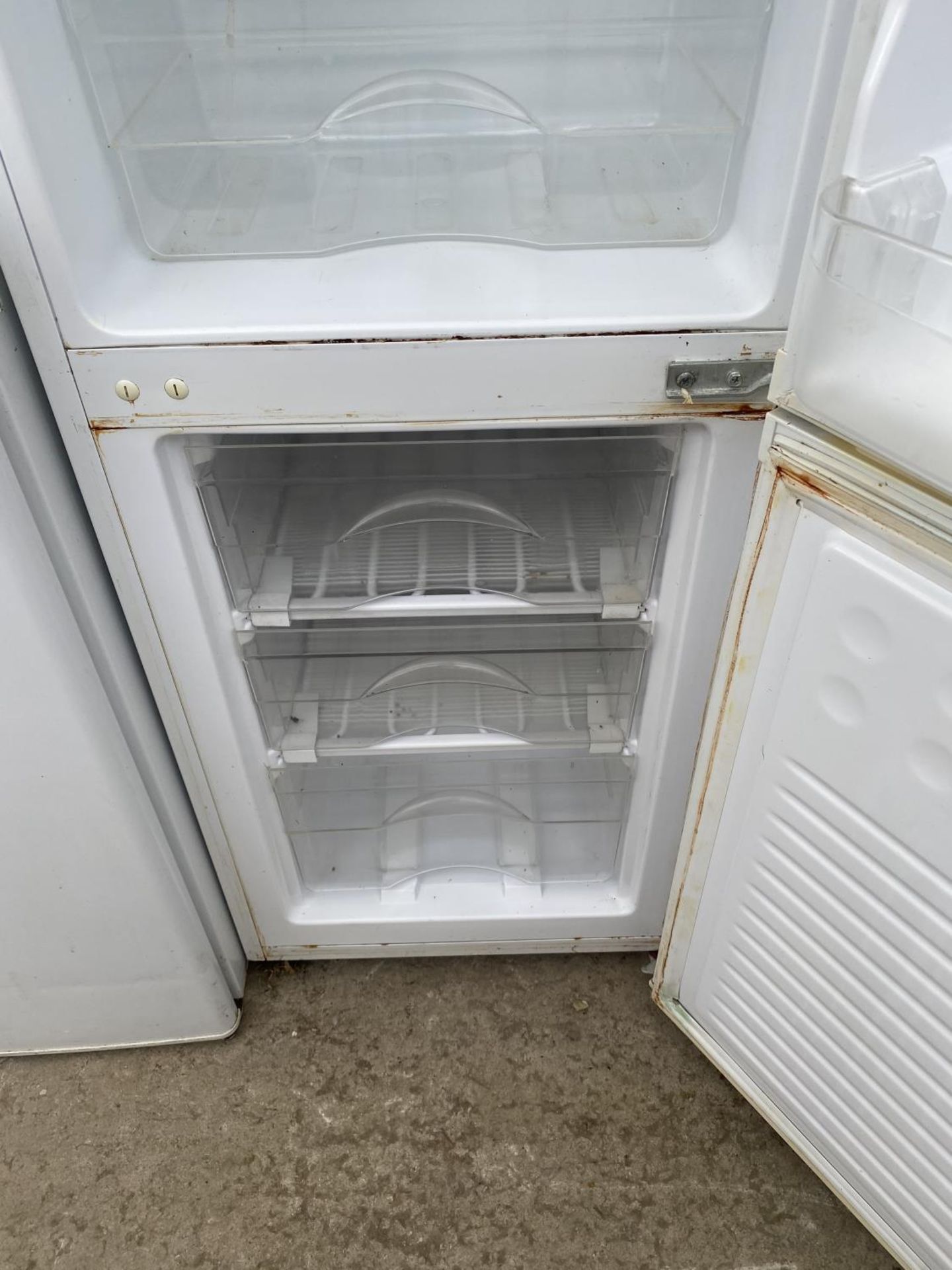 A WHITE UPRIGHT FRIDGE FREEZER BELIEVED IN WORKING ORDER BUT NO WARRANTY - Image 4 of 4