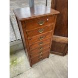 A NARROW PINE CHEST OF EIGHT DRAWERS WITH BRASS HANDLES W: 21 INCHES