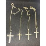 FOUR SILVER CHAINS WITH VARIOUS CROSS PENDANTS