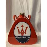 A RED MASERATI FUEL CAN WITH BRASS LID