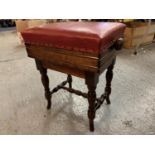 A VICTORIAN OAK ADJUSTABLE PIANO STOOL WITH RED LEATHER SEAT