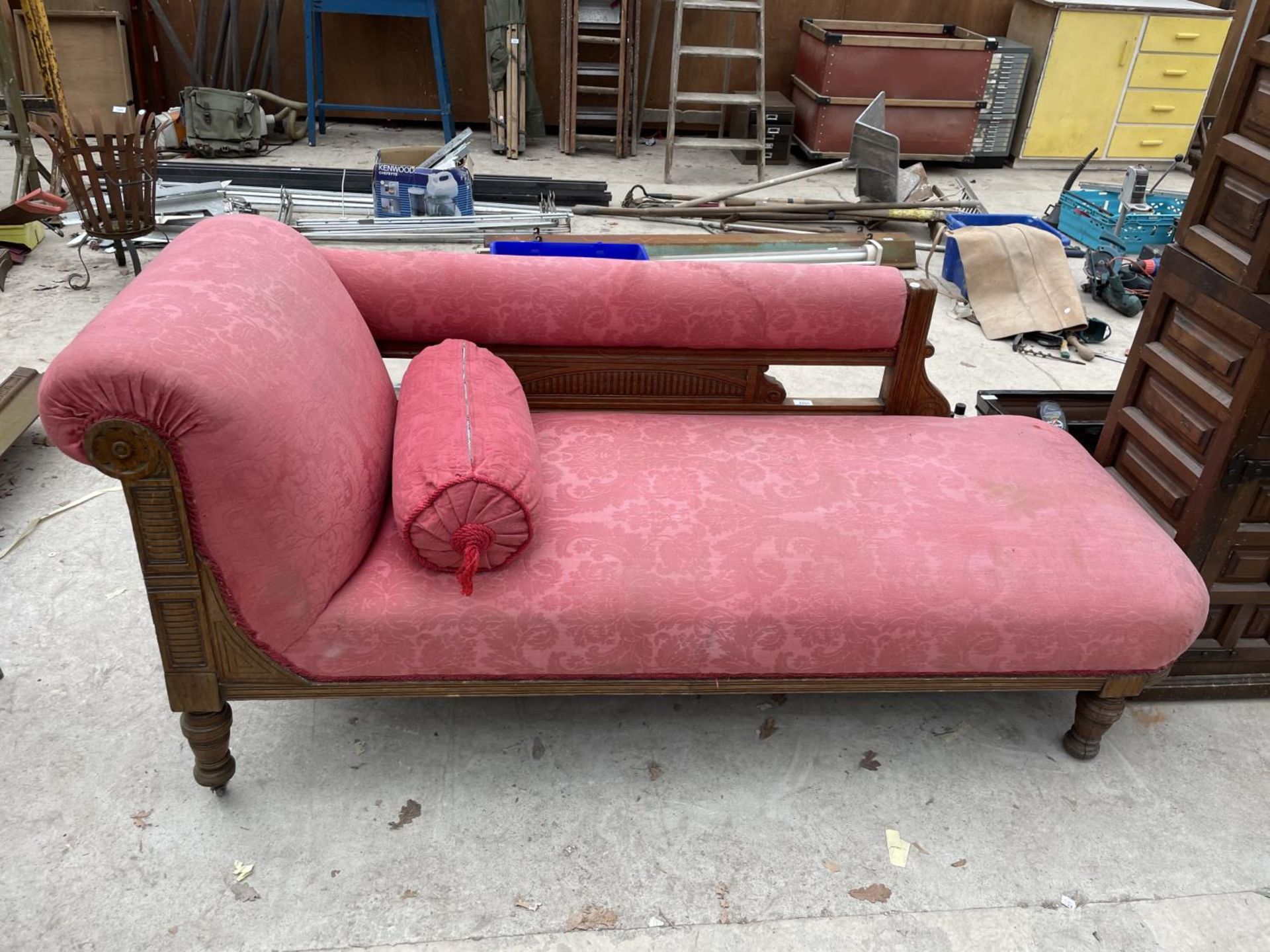 A VICTORIAN OAK FRAME CHAISE LONGUE