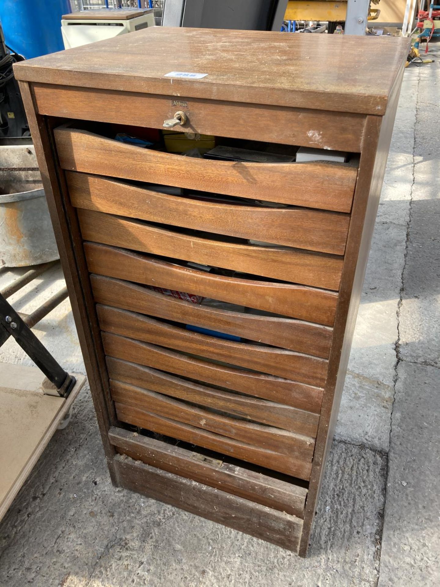 A LOCKABLE WOODEN TOOL SAFE WITH TEN DRAWERS CONTAINING DRILL BITS, SHEET METAL CUTTERS, RIVETS SETS