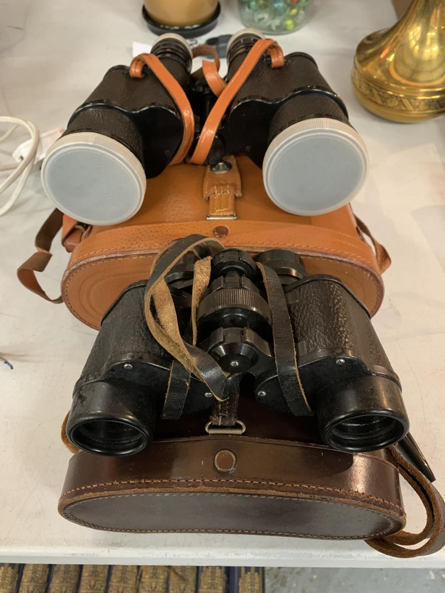 TWO PAIRS OF BINOCULARS WITH CASES