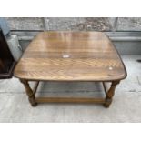 AN ERCOL ELM COFFEE TABLE ON TURNED LEGS, 29" SQUARE