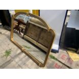 A REPRODUCTION GILT FRAMED MIRROR 54" WIDE