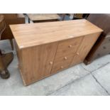 A PINE EFFECT CABINET WITH TWO DOORS AND THREE DRAWERS
