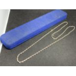 A SILVER ROPE CHAIN 22 INCHES LONG IN A PRESENTATION BOX