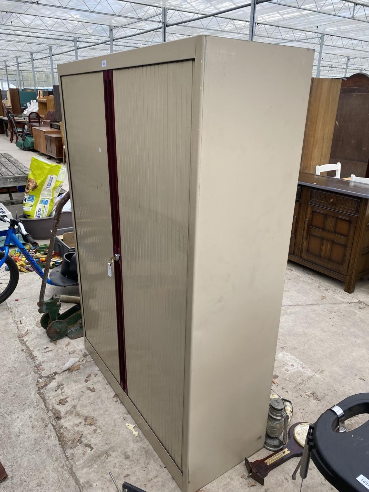 A METAL STORAGE CUPBOARD WITH TWO DOORS AND KEYS