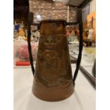 AN ARTS & CRAFTS COPPER AND IRON HANDLED VASE WITH EMBOSSED DRAGON AND CROWN DECORATION