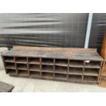 A VINTAGE WOODEN 21 SECTION PIGEON HOLE STORAGE BENCH