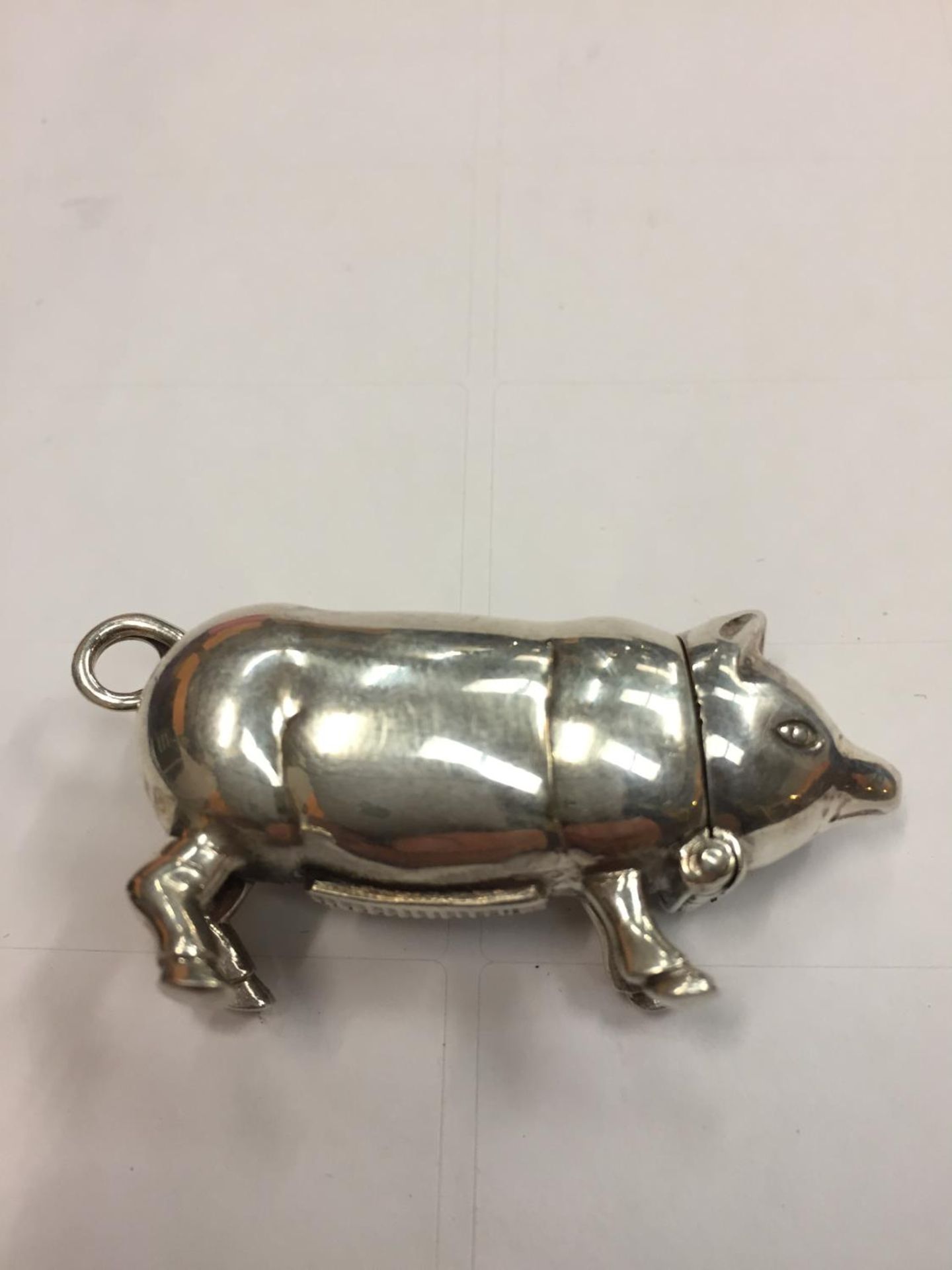 A SILVER VESTA CASE IN THE DESIGN OF A PIG