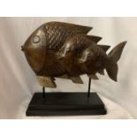 A VERY LARGE HARD WOOD FISH MOUNTED ON A PLINTH OF THE SAME H: APPROX. 45CM