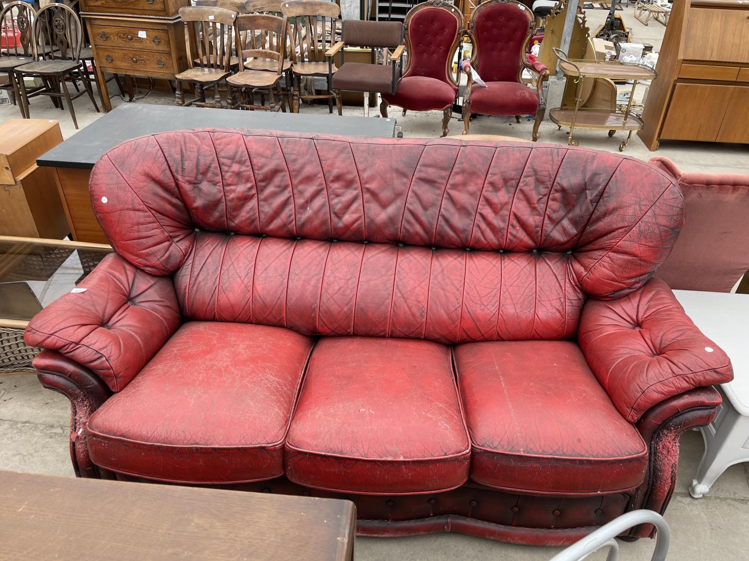 AN OXBLOOD THREE SEATER SETTEE