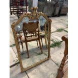 A REPRODUCTION GILT FRAMED WALL MIRROR