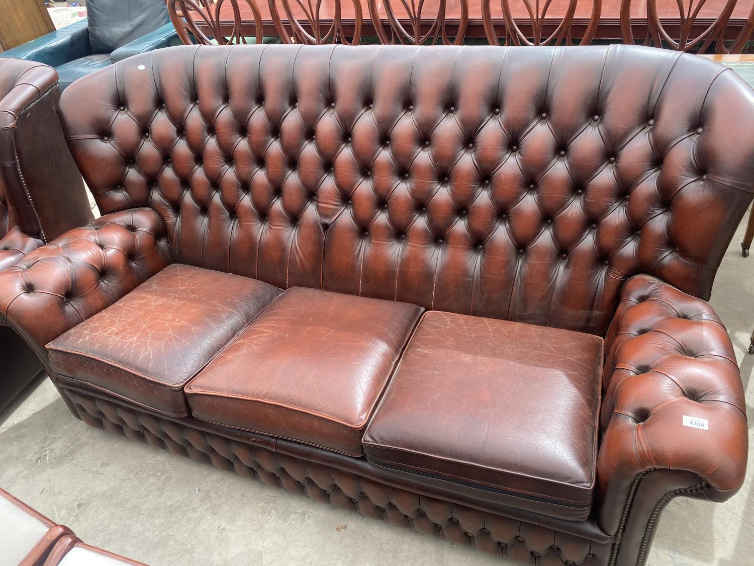 AN OXBLOOD 3 SEATER BUTTON BACK SETTEE