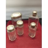 FIVE VARIOUS SCENT AND PODER BOTTLES WITH HALLMARKED LONDON LIDS