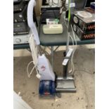 A GTECH VACUUM AND A BISSELL QUICKWASH