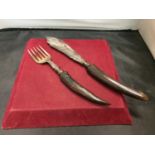 A HORN HANDLED SERVING KNIFE AND FORK WITH HALLMARKED BIRMINGHAM SILVER COLLARS