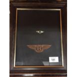 TWO BENTLEY BADGES IN A MAHOGANY FRAME