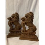 A LARGE PAIR OF CAST IRON LION DOOR STOPS