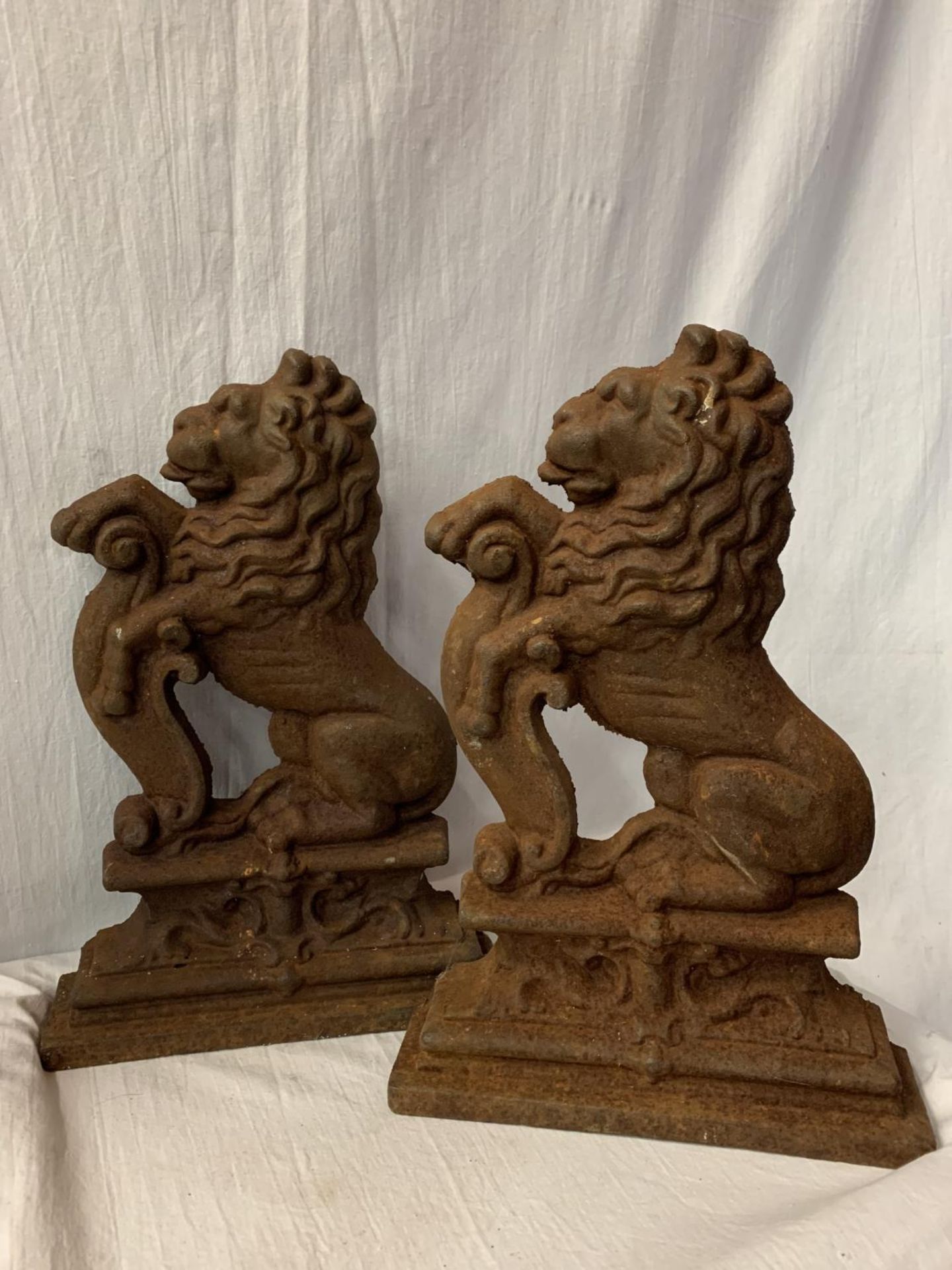 A LARGE PAIR OF CAST IRON LION DOOR STOPS