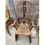 A 19TH CENTURY ELM AND BEECH ROCKING CHAIR WITH TURNED SPINDLES AND A PIERCED SPLIT BACK