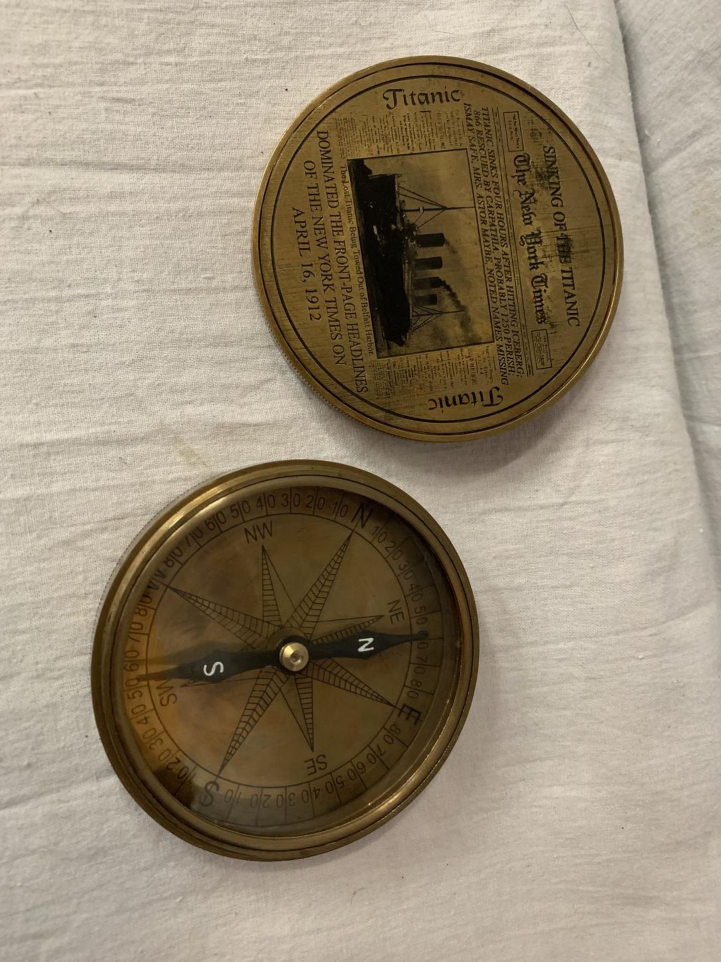 A BRASS COMPASS WITH ENGRAVING RELATING TO THE TITANIC