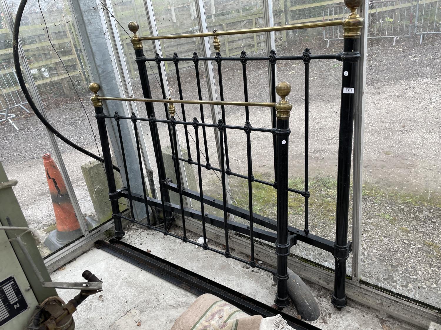 A VICTORIAN 4' 6" BRASS AND IRON BEDSTEAD