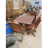 A TEAK GARDEN FURNITURE SET TO INCLUDE A TABLE AND SIX FOLDING CHAIRS (TABLE TOP 160CM X 90CM)